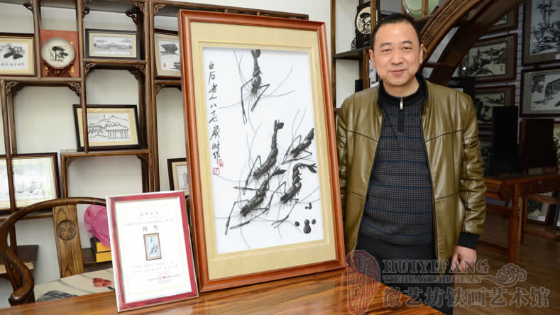 蕪湖徽藝坊鐵畫(huà)藝人楊開(kāi)勇作品《蝦》獲得徽工獎(jiǎng)銀獎(jiǎng)（制作者與作品和證書(shū)合影）