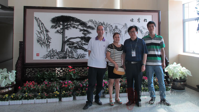 昆明長(zhǎng)水國(guó)際機(jī)場(chǎng)定制的辦公樓大廳大型紅木迎客松鐵畫(huà)屏風(fēng)與客戶(hù)合影
